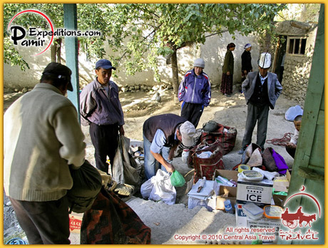 Uzgarysh village. Horsemen are preparing our luggage for transportation.